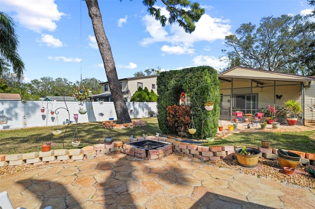 exterior space featuring ceiling fan, a yard, a patio area, and a fire pit