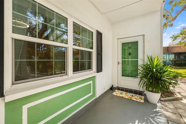 view of exterior entry with stucco siding