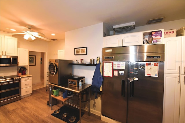 kitchen featuring white cabinetry, ceiling fan, stainless steel appliances, and light wood-type flooring