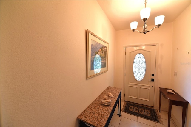 doorway to outside featuring a notable chandelier and light tile patterned floors