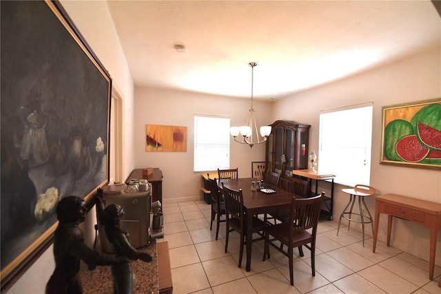 dining area featuring light tile patterned floors and a chandelier