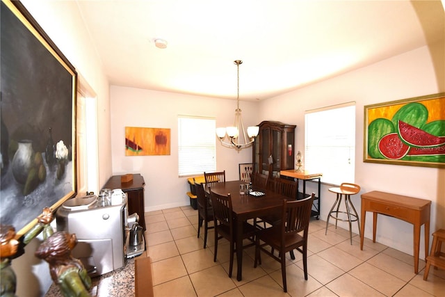 dining room featuring a chandelier and light tile patterned flooring