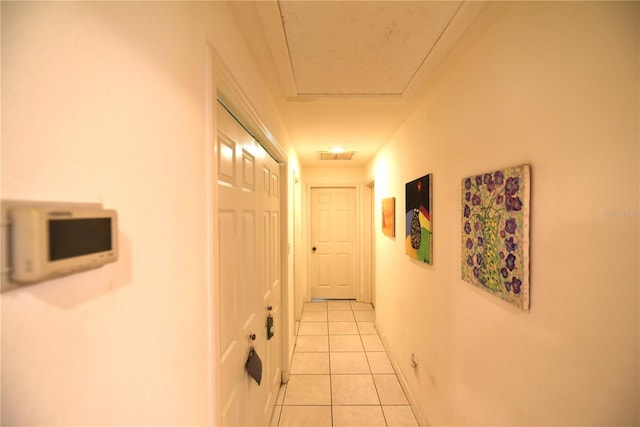 hall with light tile patterned floors