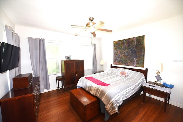 bedroom with dark hardwood / wood-style floors and ceiling fan