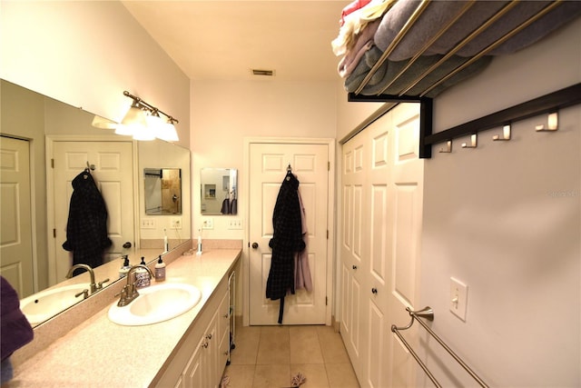 bathroom featuring tile patterned flooring and vanity