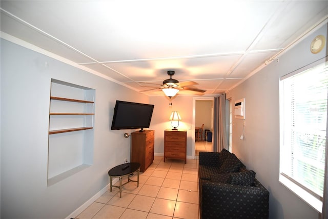 living room featuring light tile patterned flooring, ceiling fan, and a wealth of natural light