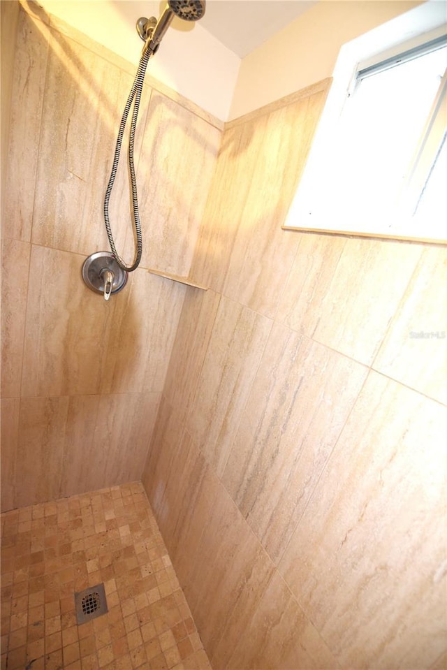 bathroom with a tile shower