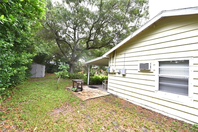 view of yard featuring a patio and a storage shed