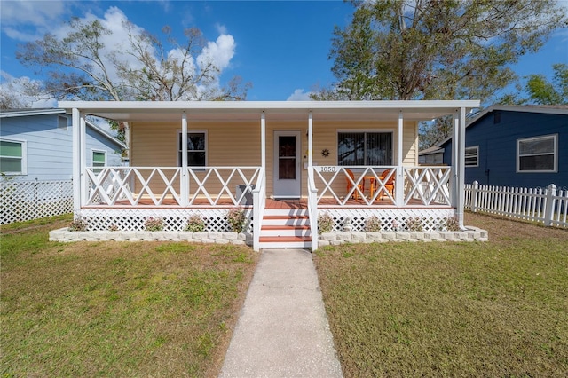 view of front of property with covered porch and a front lawn