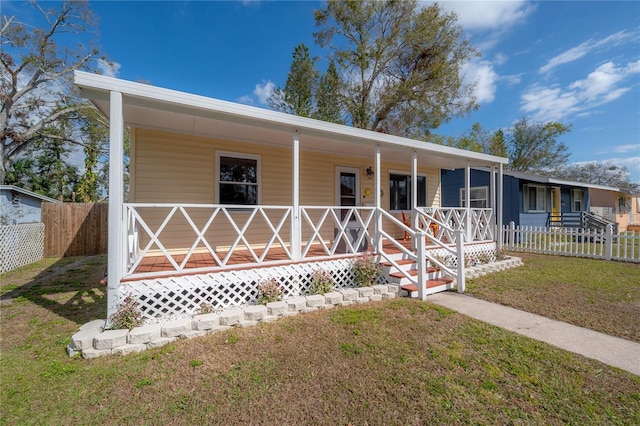 view of front of home with a porch and a front yard