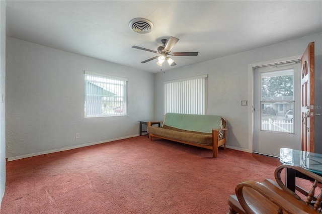 living area featuring ceiling fan and carpet flooring