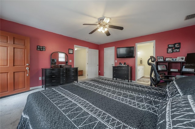 carpeted bedroom with ceiling fan and ensuite bath