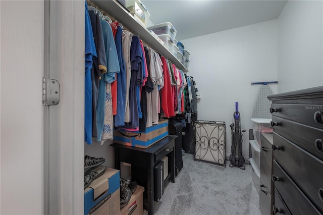 walk in closet featuring light colored carpet