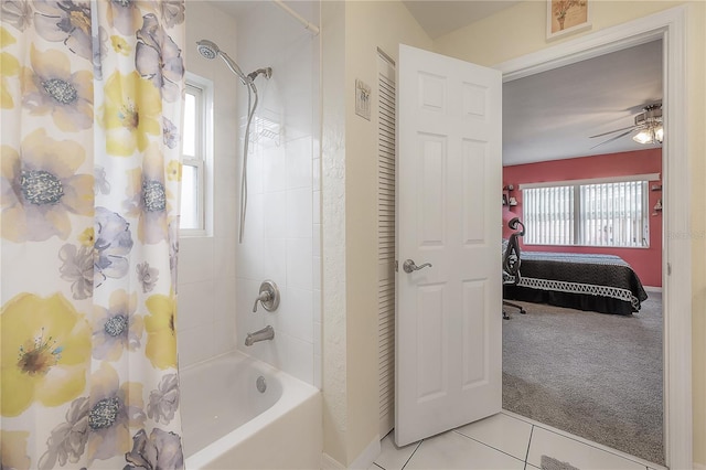 bathroom with ceiling fan, tile patterned floors, a healthy amount of sunlight, and shower / bath combo with shower curtain