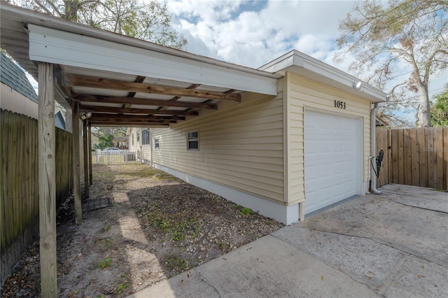 exterior space with a garage and a carport