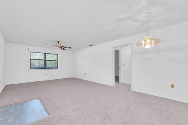 spare room with ceiling fan, visible vents, and light colored carpet