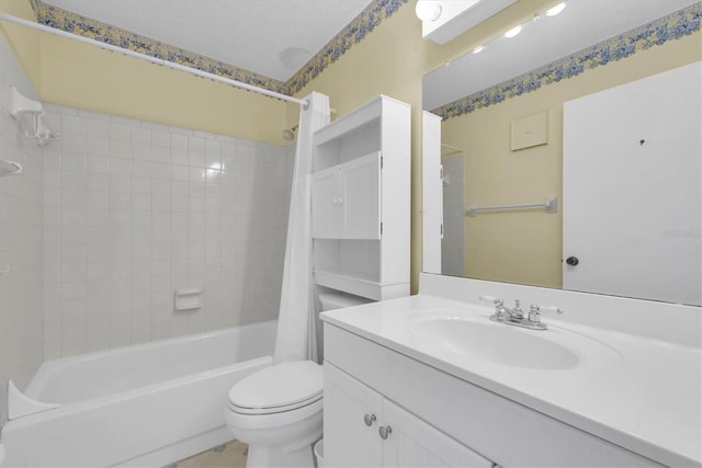 bathroom featuring shower / bath combo with shower curtain, a textured ceiling, toilet, and vanity