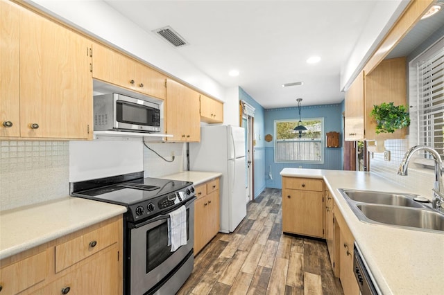 kitchen featuring dark wood-type flooring, light brown cabinetry, sink, pendant lighting, and stainless steel appliances