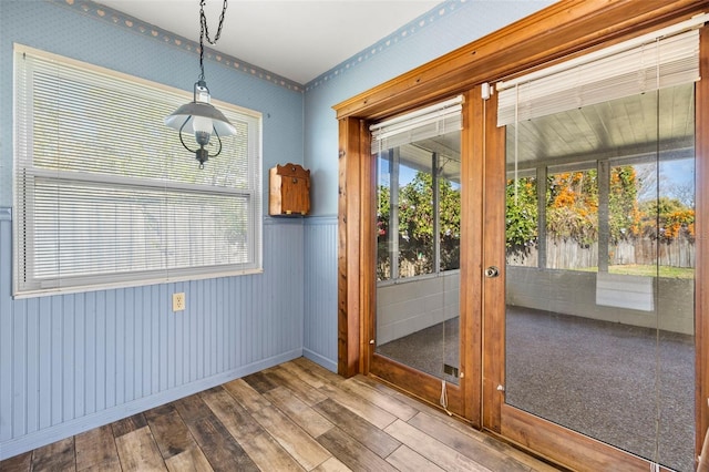 doorway to outside featuring hardwood / wood-style flooring and a wealth of natural light