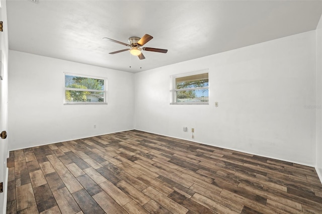 unfurnished room featuring dark hardwood / wood-style flooring, ceiling fan, and a healthy amount of sunlight