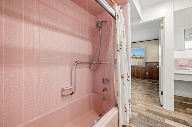 bathroom featuring hardwood / wood-style floors, shower / bath combo with shower curtain, and wood walls