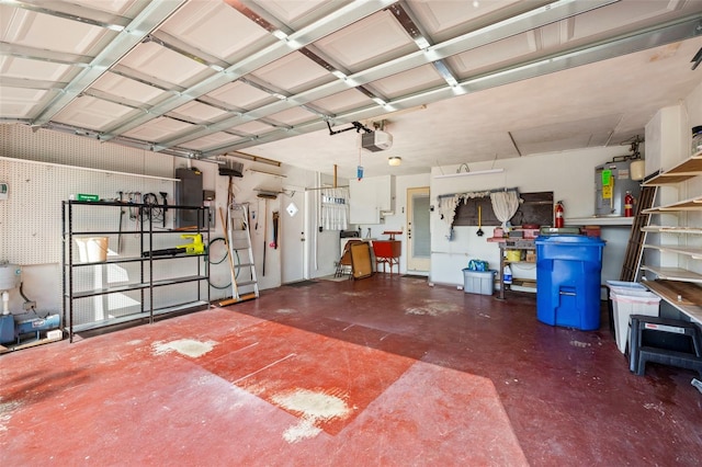 garage with a garage door opener, a workshop area, and electric panel