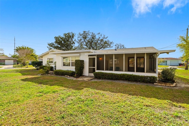 view of front of house featuring a front lawn and a sunroom