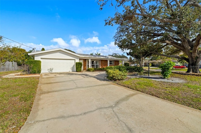 single story home featuring a garage and a front lawn