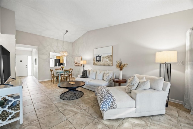 living room featuring lofted ceiling and a notable chandelier