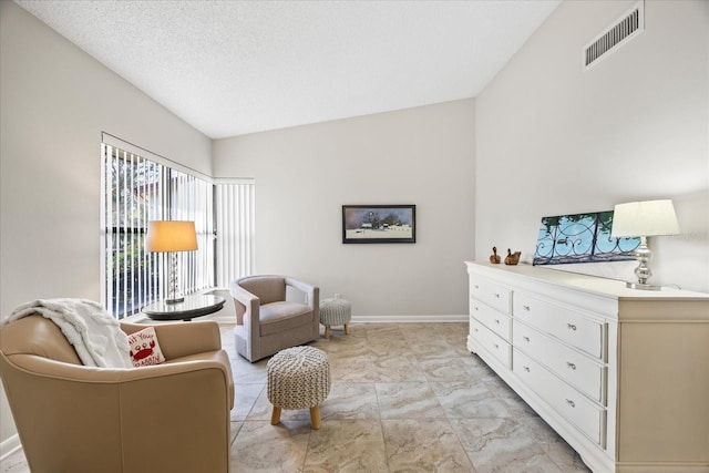 living area with a textured ceiling