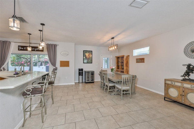 dining area with plenty of natural light, baseboards, and light tile patterned flooring