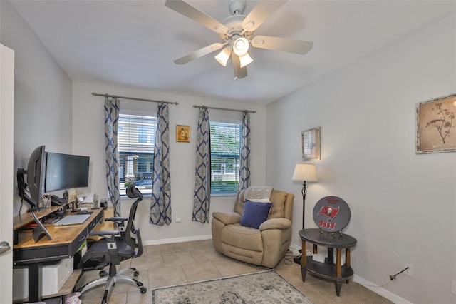 office space featuring a ceiling fan, baseboards, and light tile patterned floors