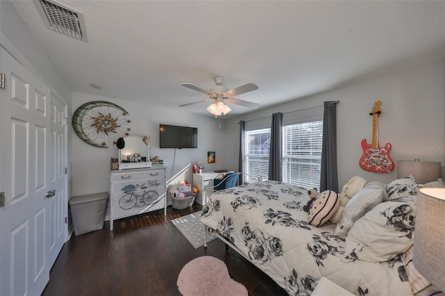 bedroom featuring wood finished floors, a ceiling fan, and a closet