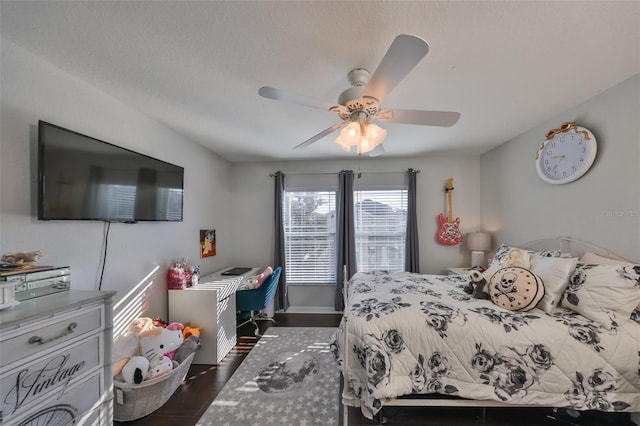 bedroom with dark wood-style flooring and a ceiling fan