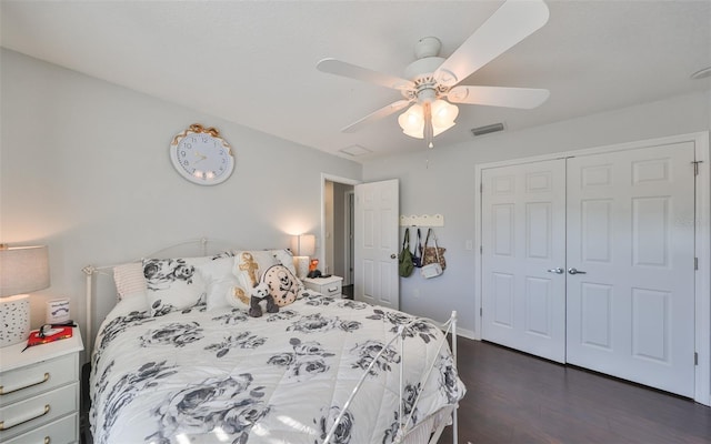 bedroom featuring dark wood finished floors, a closet, a ceiling fan, and baseboards