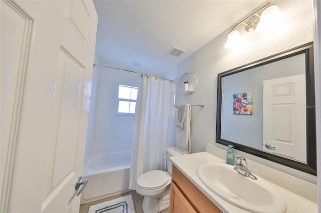 full bath with vanity, toilet, a textured ceiling, shower / tub combo, and tile patterned floors