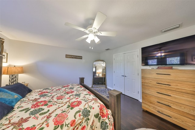 bedroom with dark wood-style flooring, a closet, and ceiling fan