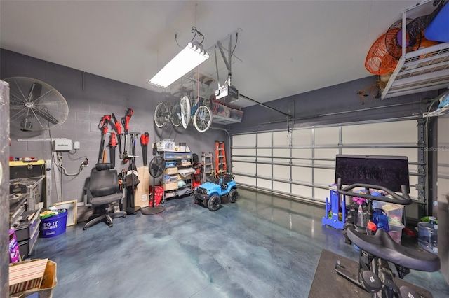 garage featuring a garage door opener and concrete block wall