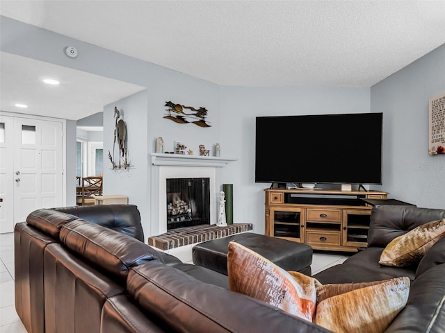 tiled living room featuring a textured ceiling