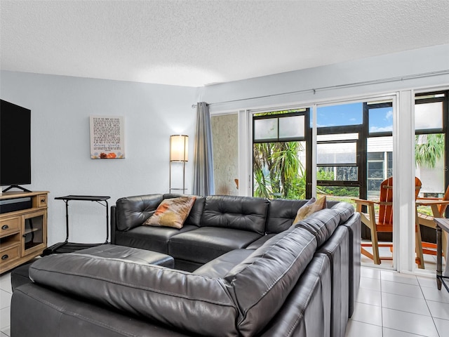 living room with a textured ceiling and light tile patterned floors