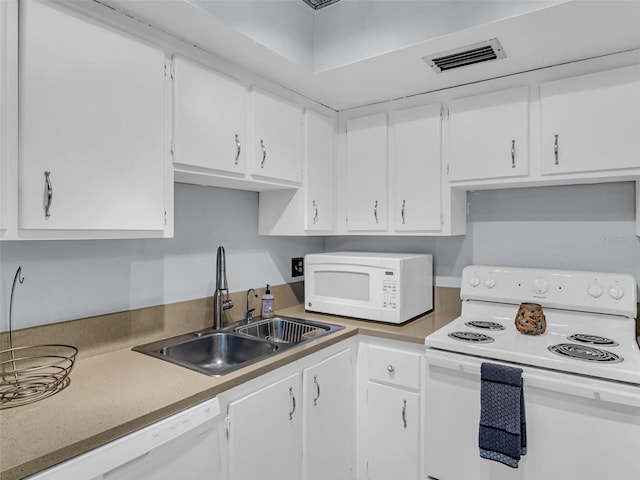 kitchen with white cabinetry, white appliances, and sink