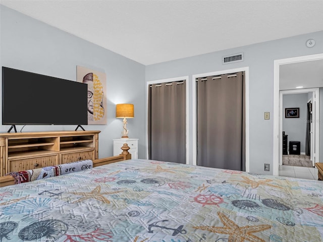 bedroom featuring multiple closets