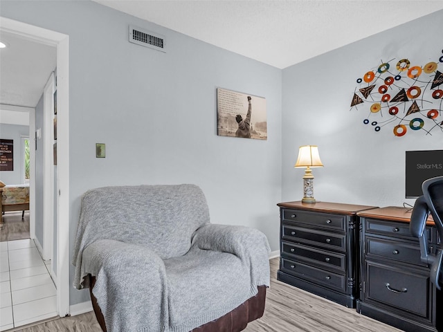 sitting room featuring light hardwood / wood-style flooring