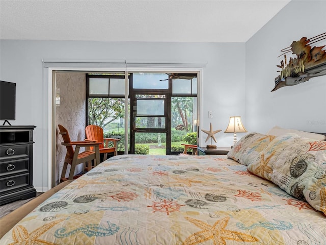 bedroom with access to exterior and a textured ceiling