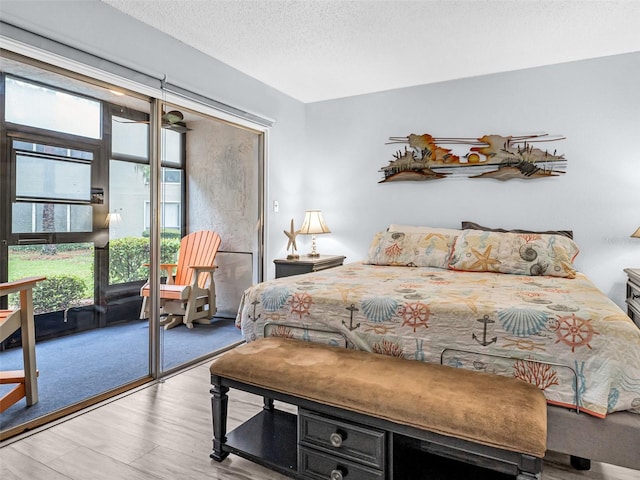 bedroom featuring a textured ceiling and light wood-type flooring