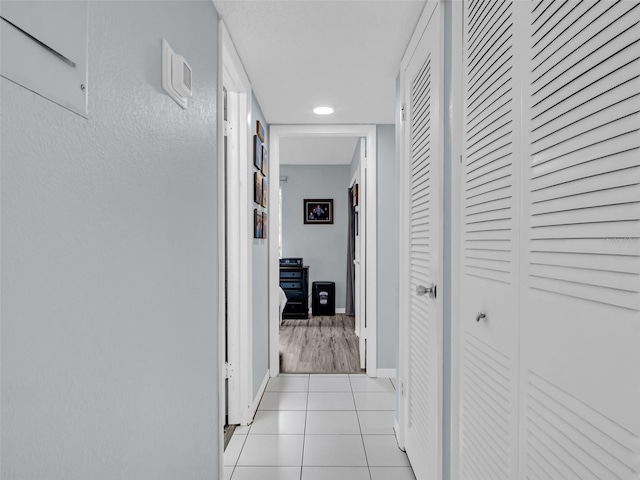 hall featuring light tile patterned floors