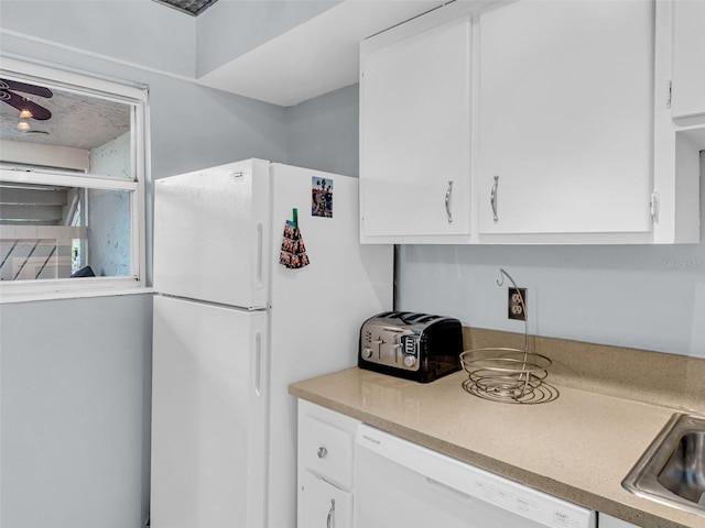 kitchen featuring white cabinetry, white appliances, and sink