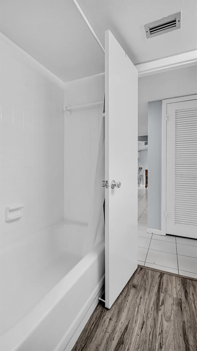 bathroom featuring shower / tub combination and hardwood / wood-style floors