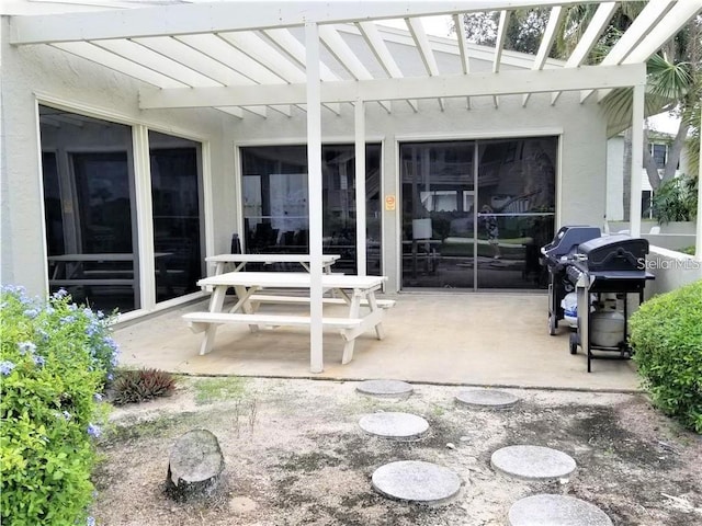 view of patio featuring area for grilling and a pergola