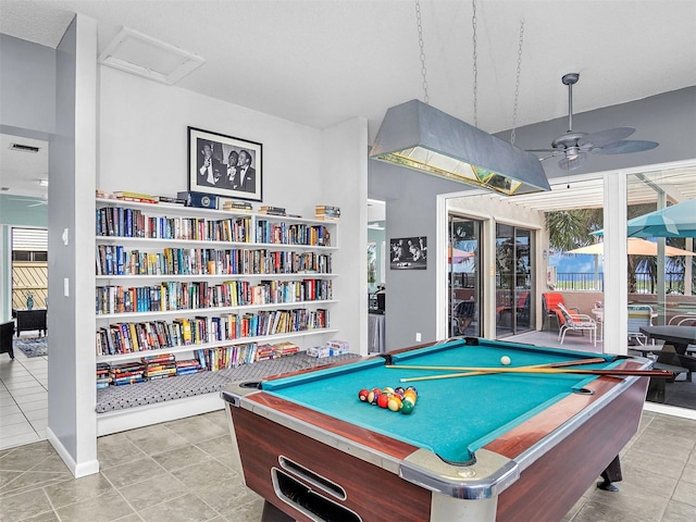 recreation room with light tile patterned floors and ceiling fan